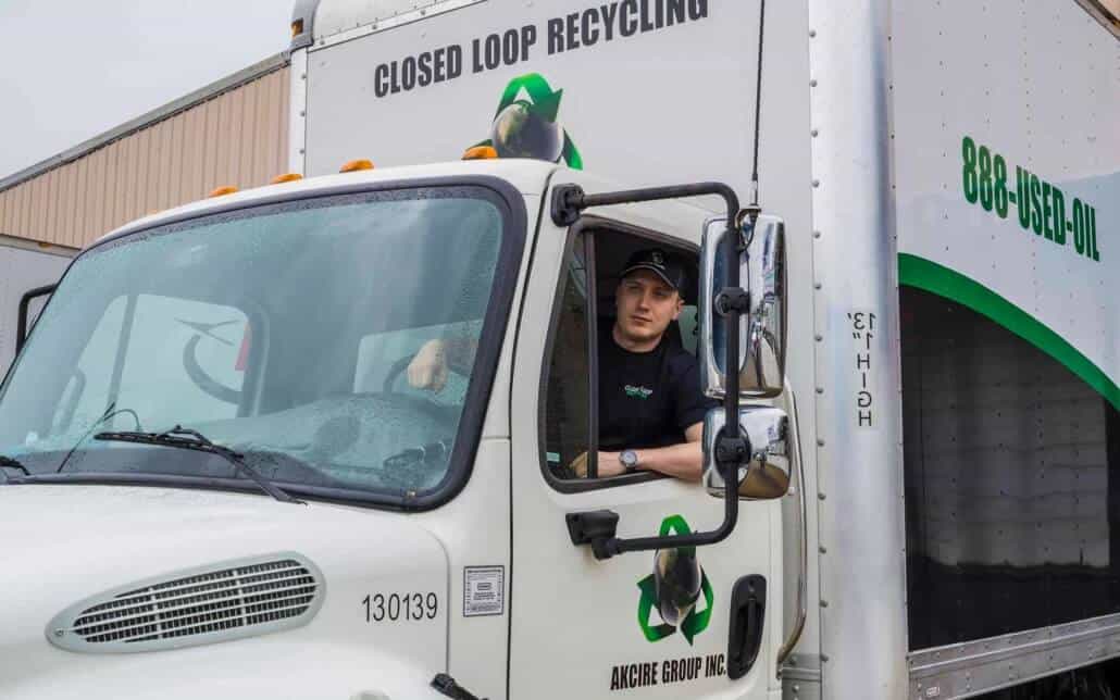 closed loop employee driving a box truck